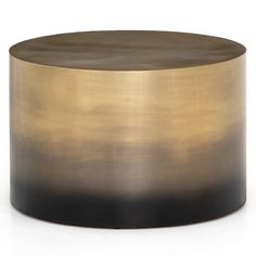 a gold and black round table sitting on top of a white floor