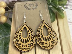 These earrings are meticulously handcrafted with the utmost attention to detail, showcasing an elegant teardrop shape. The use of wood adds a natural element, creating a unique and charismatic piece of jewelry.  The captivating aspect of these earrings lies in the exquisite mandala pattern gracefully engraved onto the wooden surface. Each intricate curve and line of the mandala brings a sense of balance and harmony to the overall design. The choice of a mandala pattern further enhances the earrings, symbolizing unity, mindfulness, and infinite possibilities. The delicate combination of the teardrop shape and the mesmerizing mandala pattern makes these earrings not only a stunning fashion accessory but also a meaningful representation of art and spirituality.  With their distinctively intri Brown Teardrop Hoop Earrings As Gift, Brown Teardrop Hoop Earrings For Gifting, Brown Teardrop Hoop Earrings For Gift, Teardrop Chandelier Earrings Gift, Teardrop Pendant Earrings For Gift, Teardrop Chandelier Earrings With Ear Wire As Gift, Earrings Caption, Wood Mandala, Mandala Earrings