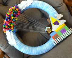 a child's birthday decoration made out of construction paper and plastic beads on top of a chair