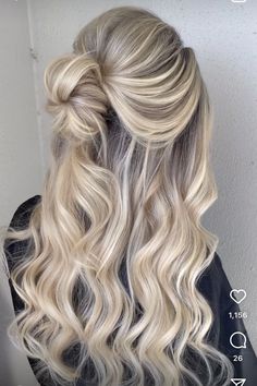 a blonde woman with long wavy hair styled into a half updo