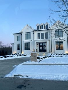 a large white house with snow on the ground