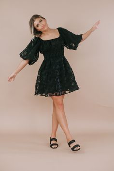 Define elegance in this timeless mini dress. Featuring, an elevating cinched waistline, an elevating floral design throughout, and an ultra feminine short puff sleeve. Such a lovely piece to style throughout the season! Neckline: Square Floral dress Black mini Date Night dress Fabric: 50% Polyester, 50% Rayon; Lining: 80% Rayon, 20% Polyester Short puff style sleeve Cinched elastic waistband Lined Dainty floral design throughout Imported Fit: True to size! Model Specs: Emily is wearing a size sm Elegant Mini Dress With Smocked Bodice And Short Sleeves, Chic Puff Sleeve Mini Dress For Garden Party, Chic Mini Puff Sleeve Dress For Garden Party, Spring Evening Puff Sleeve Dress With Smocked Bodice, Spring Fit And Flare Mini Dress With Puff Sleeves, Flirty Puff Sleeve Dress For Spring Evening, Spring Fit And Flare Puff Sleeve Dress, Flirty Puff Sleeve Dress For Evening In Spring, Chic Mini Dress With Gathered Sleeves For Garden Party