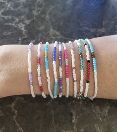 This listing is a collection of 10, dainty minimalistic beaded bracelets! Boho stackable bracelets strung on strong beading string, very durable making them perfect for everyday wear. Wonderful gift for someone or yourself! Each bracelet is sold separately and numbered in pictures 2, 3, and 4 so you can make sure you're getting the right bracelet. Comes in many sizes, and let me know if you don't see yours! All of our jewelry comes gift-wrapped in a little bag, making them the perfect gifts for best friends, gifts for her or to treat yourself! Or would be cute friendship bracelets. They ship very quickly! Spice up your jewelry collection with these beaded bracelets. If you have any questions or anything else feel free to contact me! Seed Beaded bracelets All hand-made by simplyradiantjewel Stackable Heishi Beads Friendship Bracelets, Gift Heishi Beads Hand Wrapped Beaded Bracelets, Trendy Hand Wrapped Beaded Bracelets For Everyday, Adjustable Dainty Stretch Bracelet, Adjustable Stackable Friendship Bracelets With Round Beads, Stackable Friendship Bracelets With Round Beads, Minimalist Beaded Stretch Bracelet For Gift, Dainty Hand-wrapped Beaded Bracelets For Everyday, Dainty Hand Wrapped Beaded Bracelets For Everyday