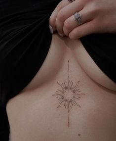 a close up of a person's stomach with a tattoo on the top of it