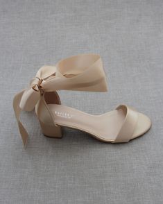 "Classy satin block heel with satin ribbon ankle tie. Simple yet elegant are great combination and will definitely be a favorite. DETAILS: FIT: RUNS LARGE, ORDER ONE SIZE DOWN HEEL HEIGHT: 1.5 inch (Kids) & 2 inches (Women) RIBBON WIDTH: 1.5 inches COLORS AVAILABLE: Black, Burgundy, Champagne, Ivory, Navy, White, Light Blue, Soft Blush UPPER: Synthetic upper and lining MATERIALS: Mandmade outsole STYLE NAME: NAOMI KIDS SIZES: Size 11- 7.65 inch Size 12 - 7.85 inch Size 13 - 8.15 inch Size 1 Low Heel Satin Wedding Shoes For Summer, Summer Wedding Shoes With Satin Bow And Low Heel, Summer Wedding Shoes Satin Closed Toe, Summer Wedding Shoes In Satin With Closed Toe, Summer Satin Wedding Shoes With Closed Toe, Bridesmaid Wedding Shoes With Wrapped Low Heel, Prom Sandals With Bow And Block Heel, Block Heel Sandals With Bow For Prom, Formal Low Heel Sandals With Satin Bow