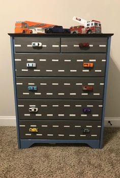 a dresser with cars and trucks on it in a child's bedroom or playroom