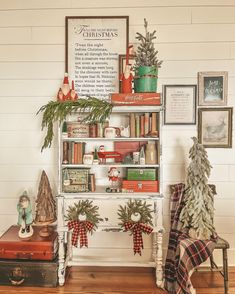 a shelf with christmas decorations on top of it next to a chair and other items