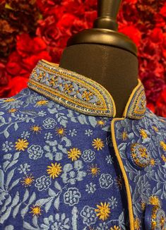 A regal blue sherwani adorned with intricate floral embroidery in gold and silver tones. The high-collared design and detailed buttons exude sophistication, making it perfect for weddings and grand celebrations. The luxurious fabric and rich embroidery make this sherwani a statement piece for any groom or special occasion. Key Features: Color: Royal blue with gold and silver floral embroidery. Design: High-collared with ornate buttons. Fabric: Rich, textured fabric for a luxurious feel. Occasion Designer Blue Kurta With Intricate Embroidery, Designer Blue Nehru Jacket With Traditional Drape, Designer Blue Cutdana Kurta, Designer Blue Traditional Wear With Dabka Work, Designer Blue Kurta For Transitional Seasons, Designer Blue Traditional Wear For Reception, Designer Blue Sets With Dabka Detailing, Designer Blue Bandhgala With Traditional Drape, Designer Blue Kurta For Festive Occasions