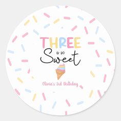 a round sticker with the words three is so sweet on it and sprinkles