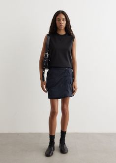 Heavily influenced by the British countryside and pop culture, JW Anderson blends luxury with casual charm using unexpected and bold palettes. Crafted from a padded polyamide construction, the Padded Cargo Mini Skirt is designed with an a-line silhouette and asymmetrical waistband and closure.  - Padded polyamide construction- Asymmetrical waistband and closure- Flap pockets with branded snap closure- Back welt pockets- Front zip closure- Silver hardware - Contrast orange lining- Mini-length- A-line fit Materials:100% Polyamide. Care:Dry clean only. Sizing: Item fits true to size. Model wears a size S and is 177cm/5'9.5". Cargo Mini Skirt, British Countryside, Jw Anderson, Skirts For Sale, Silver Hardware, Welt Pocket, Welt Pockets, Snap Closure, Pop Culture