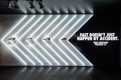 an advertisement for nike shoes is displayed on a wall with neon lights in the background