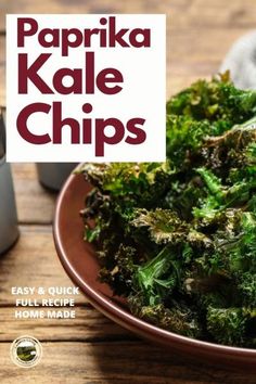 a plate full of kale chips on a wooden table with a sign that says paprika kale chips