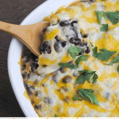 a casserole dish with black beans, cheese and cilantro