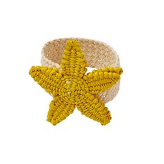 a yellow and white bracelet with a starfish on it