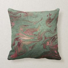 a pillow with pink and gold designs on it