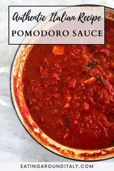 a pot filled with tomato sauce on top of a table