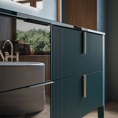 a bathroom with a sink, mirror and green cabinet