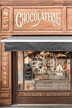 a store front with the words chocolaterie written on it's windows and an awning