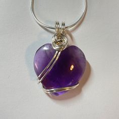 This delicate amethyst heart is the perfect gift for Valentine's Day, Mother's Day, or just to show someone how much you care. Amethyst is also the February birthstone. I set the heart with sterling silver wire, and include a free polishing cloth. You may purchase the pendant by itself or with a sterling silver snake chain that's adjustable all the way up to 22 inches. You may also choose your packaging: I can place the pendant in a red heart pouch, tuck it in a gift box, and tie it with a heart Amethyst Heart, Silver Ribbon, Silver Snake Chain, February Birthstone, All The Way Up, Heart Studs, February Birth Stone, Silver Stars, Snake Chain