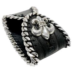 Chrome Hearts Silver Fleur de Lis Leather Bracelet | From a unique collection of vintage More Bracelets at https://www.1stdibs.com/jewelry/bracelets/more-bracelets/. Formal Engraved Leather Jewelry, Luxury Leather Bracelet Engraved, Silver Leather Bracelets For Formal Occasions, Elegant Engraved Leather Jewelry, Designer Leather Jewelry For Gift, Designer Leather Jewelry As A Gift, Formal Silver Leather Bracelets, Black Leather Bracelets With Sterling Silver Clasp, Silver Leather Cuff Bracelet Gift