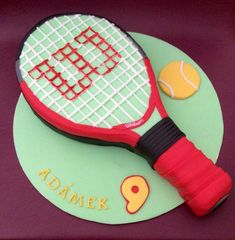 a cake shaped like a tennis racket and ball