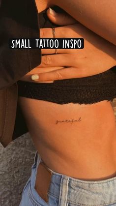 small tattoo on the side of a woman's stomach