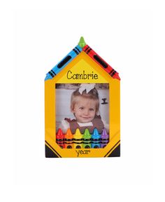 a child's photo frame with crayons in the shape of a house