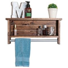 a wooden shelf with towels, soaps and other items on it