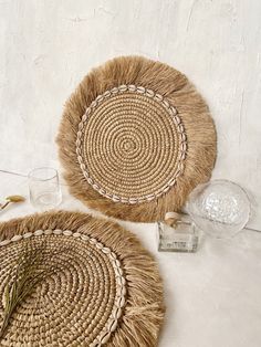 two woven placemats sitting on top of a table