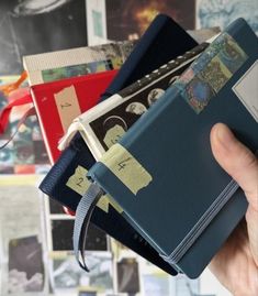 a person holding several books in their hand