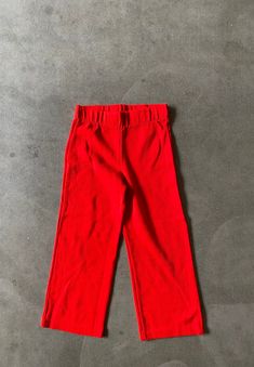 "Vintage 1980's knit pants.  Bright solid red. (Has a touch of orange.)  Wide elastic waist and straight leg fit.  Great vintage condition! label:  no maker fabric:  acrylic size:  labeled size is 6.  Please check measurements for an accurate fit.  Questions are welcome! Pants were measured across the front side lying flat. waist 9 1/2\"-11\" rise 8 1/2\" inseam 16 1/2\" outer length 23\"" Solid Red, Red Pants, Knit Pants, Label Sizes, Straight Leg Pants, Bright Red, Leg Pants, Elastic Waist, Straight Leg