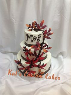 a three tiered cake decorated with leaves and the word msg on it's side