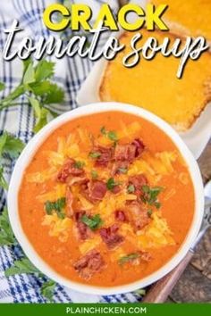 a close up of a bowl of soup with bread in the background