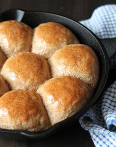 a cast iron skillet filled with rolls