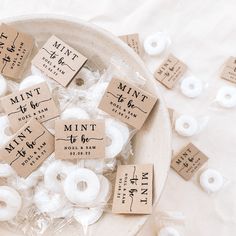 small white doughnuts are in a bowl with labels on them that say mint and mini to be