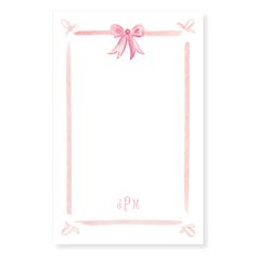 a pink card with a bow on the front and monogrammed ribbon around it