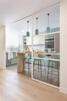 an open kitchen and dining room with large glass doors