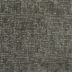 an upholstered gray and white fabric textured with small dots on the surface