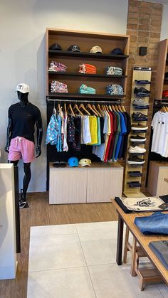 a clothing store with mannequins and shirts on display