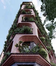 a tall brick building with plants growing on it