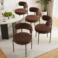 six brown chairs sitting on top of a rug in front of a table with fruit