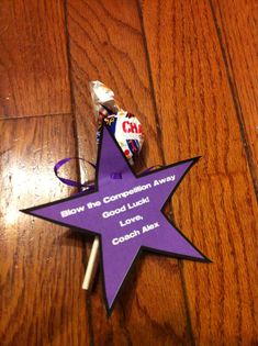 a purple star shaped ornament with candy on it sitting on a wooden table