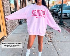 This preppy senior sweatshirt is the perfect gift for teenage girls in the Class of 2023! Featuring a crewneck style and a fun coconut girl aesthetic, this athletic school spirit shirt is sure to show off your Senior 2023 pride. ⭐️ * I T E M * I N F O* ✦ Gildan Unisex Sweatshirt ✦ This is made from a cozy, thinner material- perfect year round! ✦ Printed using Direct To Garment style- Inks are printed directly into the fabric. ✦ Different sizing may effect placement of final design. ✦ Colors may Casual Spring Sweatshirt For School, Spring School Spirit Sweatshirt With Letter Print, Pink Varsity Sweatshirt For College, Pink Crew Neck Sweatshirt For School Spirit, Fall School Sweatshirt, Senior Crewneck, Senior Sweatshirts Ideas 2024, Spring School Spirit Long Sleeve Sweatshirt, Preppy Crew Neck Top For College