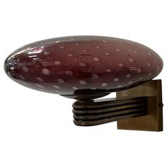 a pink and white object on a wooden stand