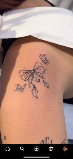 a woman with a tattoo on her stomach has a flower and butterflies tattooed on her lower back