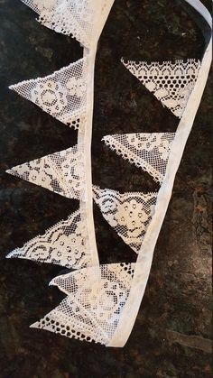 several pieces of white lace sitting on top of a table