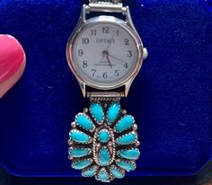 Beautiful Zuni Petit Point Turquoise Watch Sides adorn an Optics Quartz Water Resistant Watch with Second Hand.   Face of Watch is 1 inch diameter.  Zuni Watch Sides are 1.25" x 1". Excellent Condition.  Back of Zuni Silver Side is Marked "LMB" for the maker and "Sterling".  Size 7.25 before stretched. Please take the time to view all the photos carefully and zoom in to see details. Pictures are an important part of the description, and it's assumed you have viewed them all before purchasing. Wa Turquoise Quartz Watch For Gifts, Turquoise Watch Band, Turquoise Watch, Water Resistant Watch, 15% Off Sale, Details Pictures, December Birthstone, Women Wrist Watch, Wrist Watches