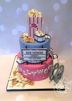 a cake that is decorated like a movie theater with popcorn and tickets on the top