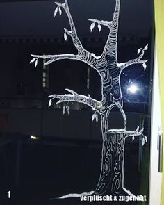 a glass window with a tree drawn on it