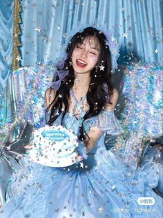 a woman sitting in a chair with a cake on her lap and confetti all over her face